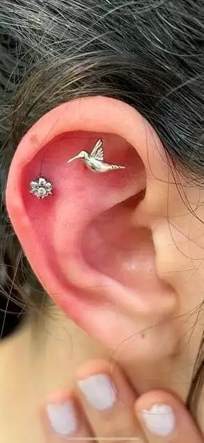 A woman with a hummingbird ear piercing named Eddie.