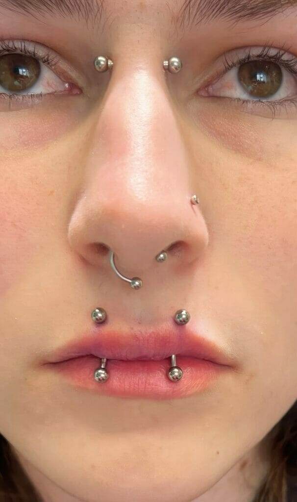 A close up of Ronnie Shaw with piercings on her nose.