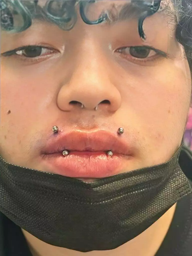 A man named Ronnie with piercings on his face.