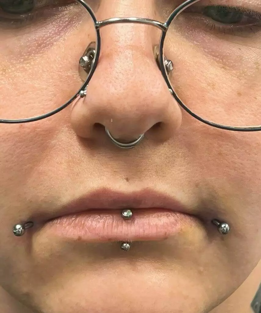 Keywords: woman, glasses, piercingsModified description: Ronnie Shaw, a woman with glasses and nose piercings.