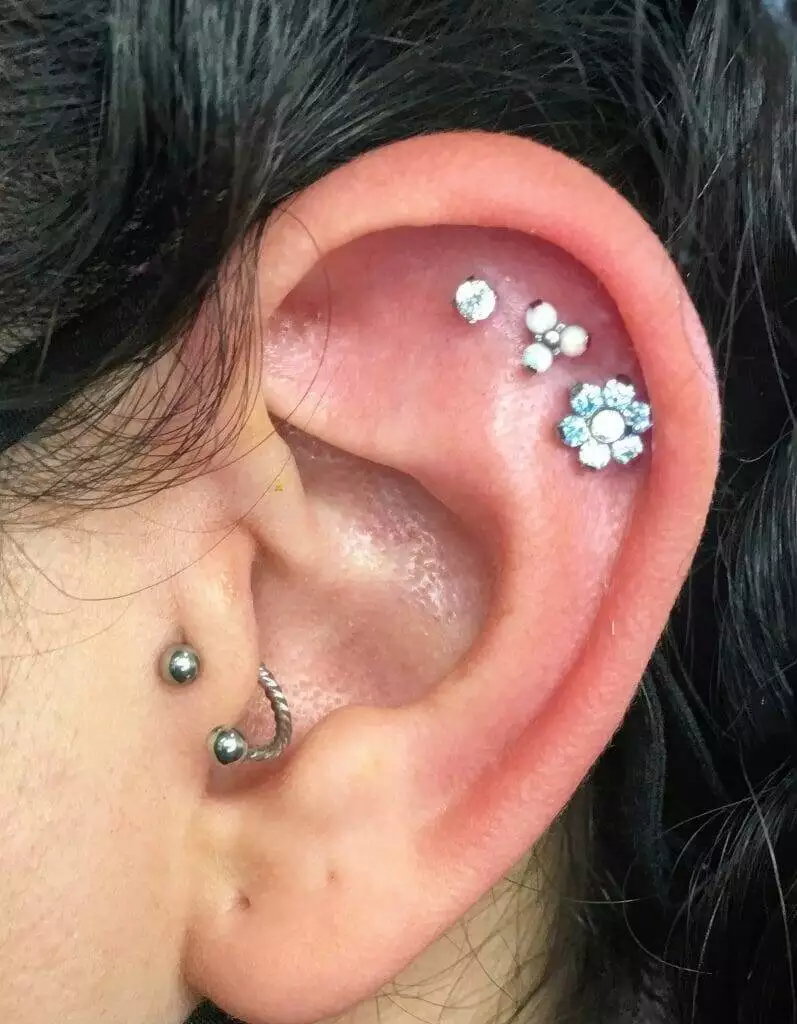 A woman's ear with a Ronnie Shaw piercing.