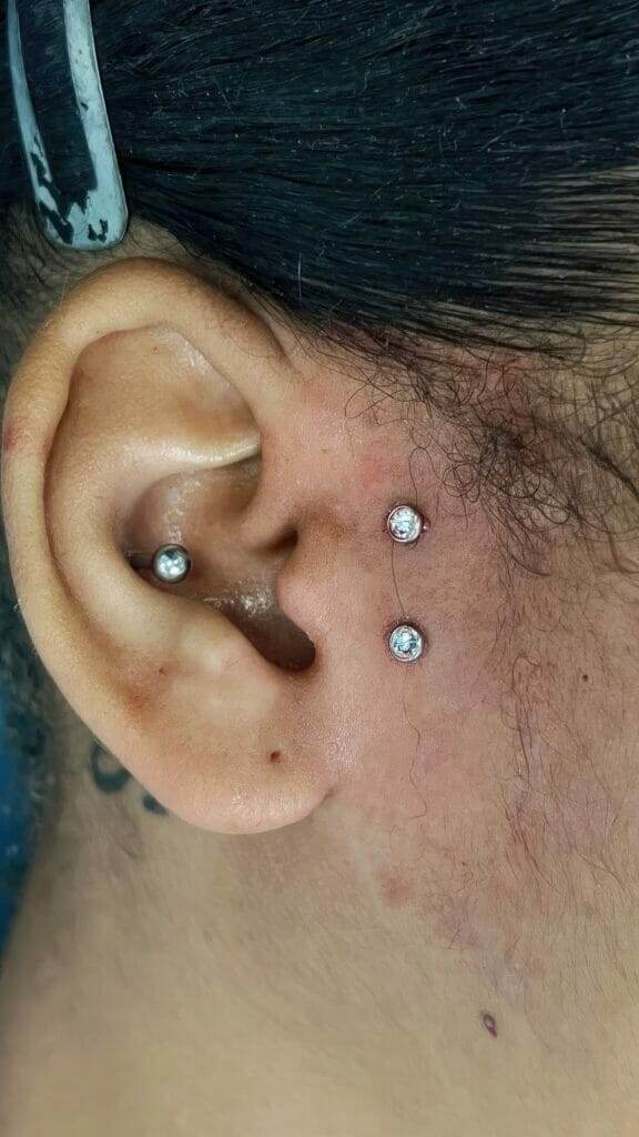 A woman named Ronnie Shaw with two piercings on her ear.