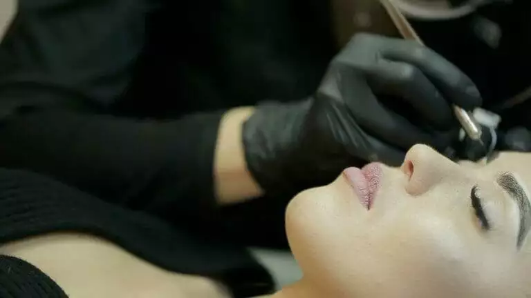 A woman getting her eyebrows done at a beauty salon.