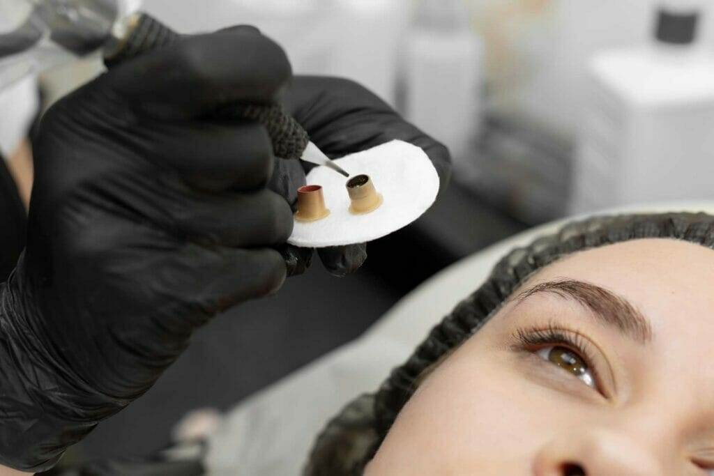 A woman getting her eyebrows tattooed.